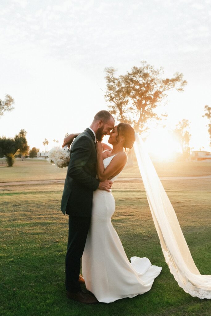 Bride and groom at sunset embracing after ceremony