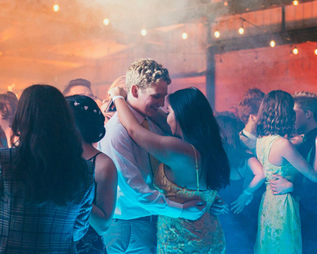 Couples dancing together at prom with a hazy atmosphere